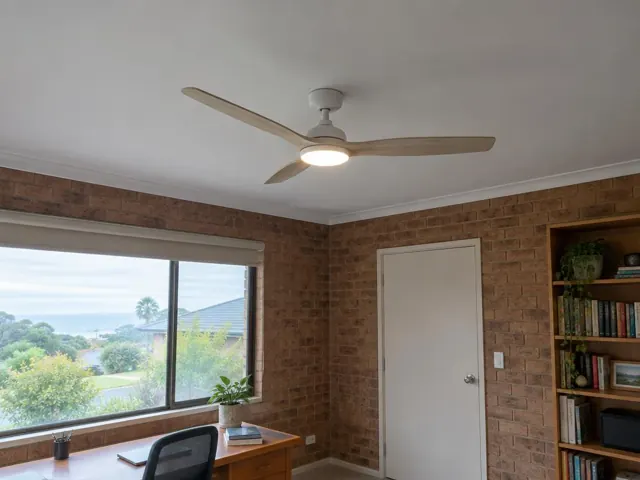 Ceiling fan on a white ceiling above a home office with brick walls and a window in The Entrance